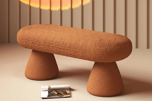 Modern orange boucle bench pouf with curved design