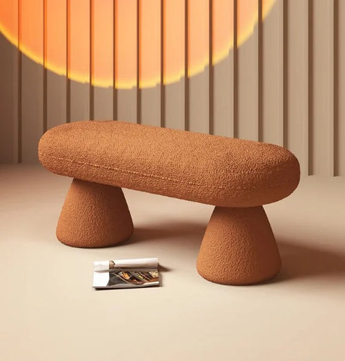 Modern orange boucle bench pouf with curved design