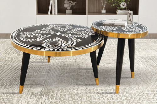 Two round side tables with black and gold designs