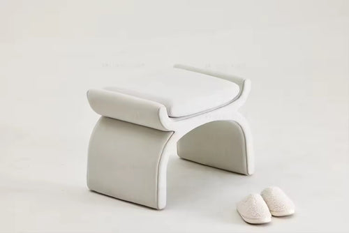 Minimalist accent pouf with unique fluid structure