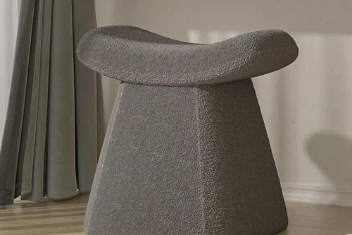 Curved grey pouf for modern interiors