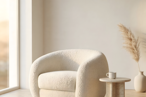 Modern white armchair in a minimalistic room with a small table and decorative elements.