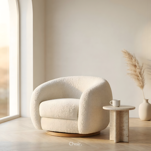 Modern white armchair in a minimalistic room with a small table and decorative elements.