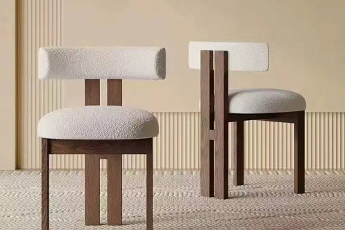 Two wooden chairs with white cushioned seats.