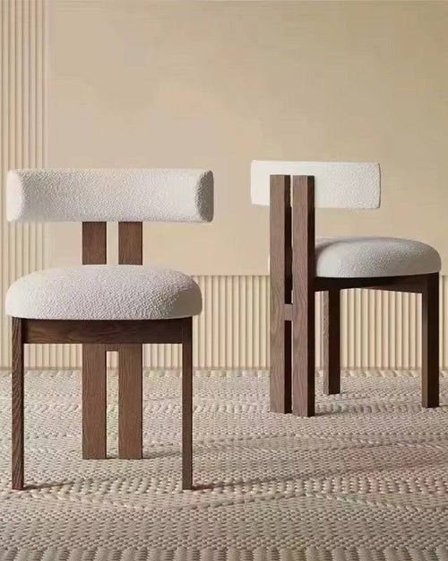 Two wooden chairs with white cushioned seats.