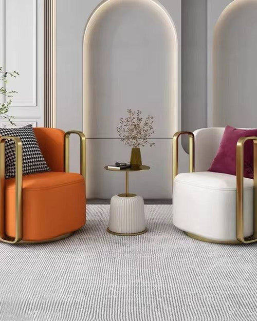 Two modern armchairs, orange and white with gold frames