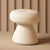 Cream pouf stool with minimalist conical base