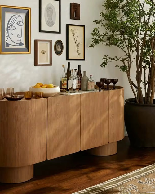 Contemporary storage console crafted in white ash veneer, featuring rounded edges, concealed storage, and a warm sculptural design for luxury interiors.