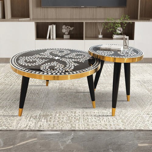 Two round side tables with black and gold designs 