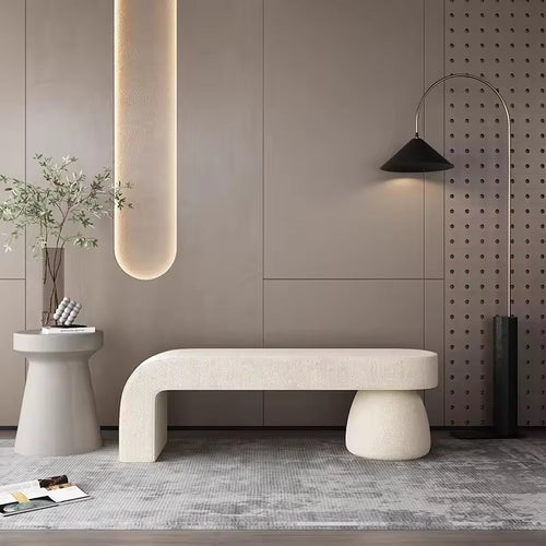 Kiana Ottoman with neutral tones and soft curves