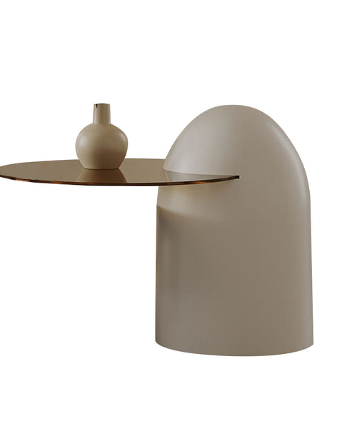 Modern side table with a cylindrical base and curved surface