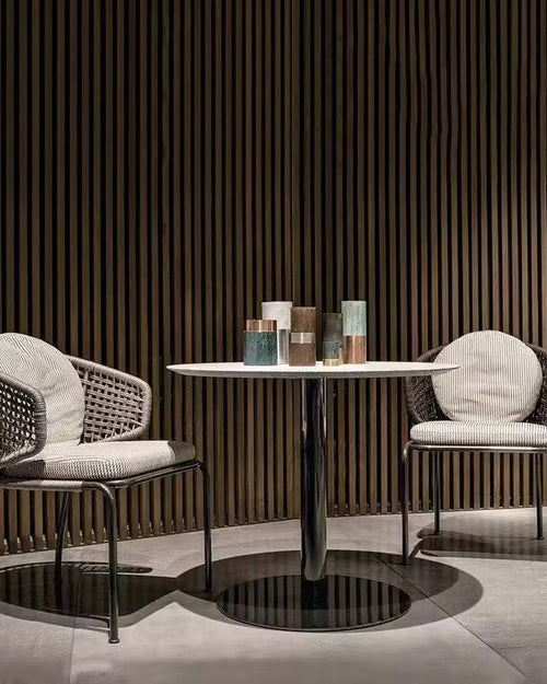 Two wicker chairs with cushioned seats 