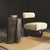 Modern sculptural accent chair featuring a plush upholstered seat and backrest, bold vertical wooden frame, and distinctive spherical wooden base.