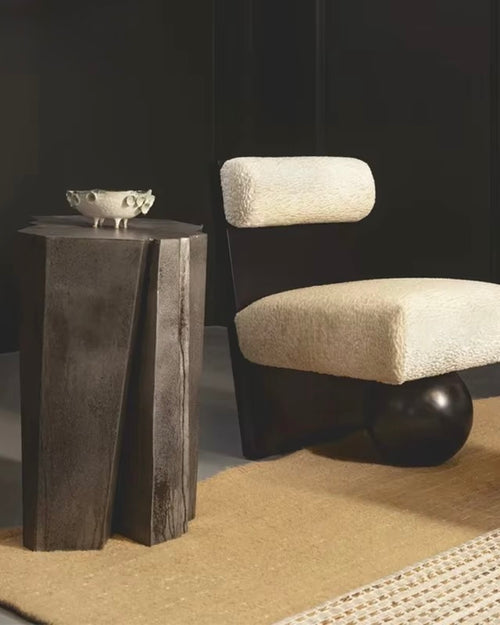 Modern sculptural accent chair featuring a plush upholstered seat and backrest, bold vertical wooden frame, and distinctive spherical wooden base.