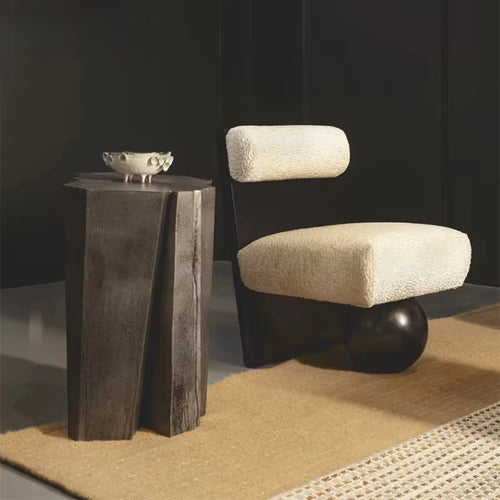 Modern sculptural accent chair featuring a plush upholstered seat and backrest, bold vertical wooden frame, and distinctive spherical wooden base.