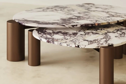 Calcita Coffee Table is a luxury set of 2 Calacatta marble cocktail tables with metallic gold pillar legs, perfect for modern living rooms and statement interiors.