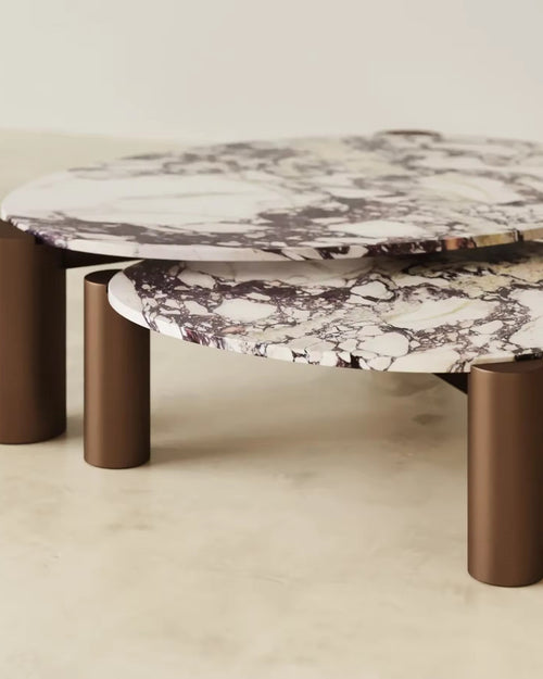 Calcita Coffee Table is a luxury set of 2 Calacatta marble cocktail tables with metallic gold pillar legs, perfect for modern living rooms and statement interiors.