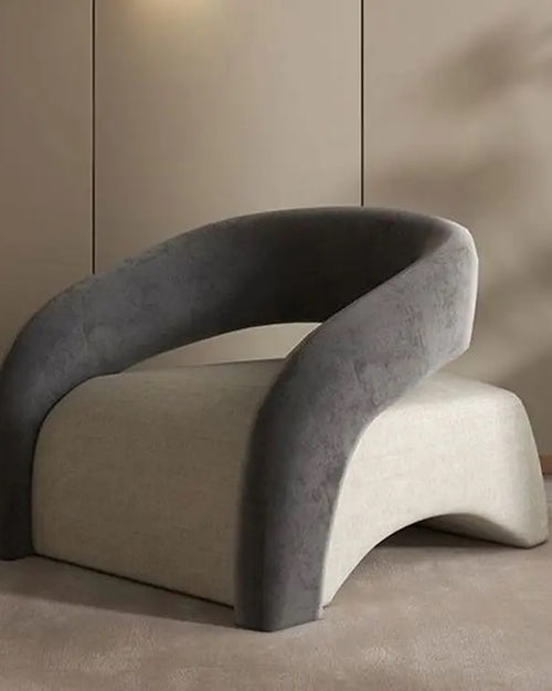 Gray designer Camry chair with sleek armrest and low base
