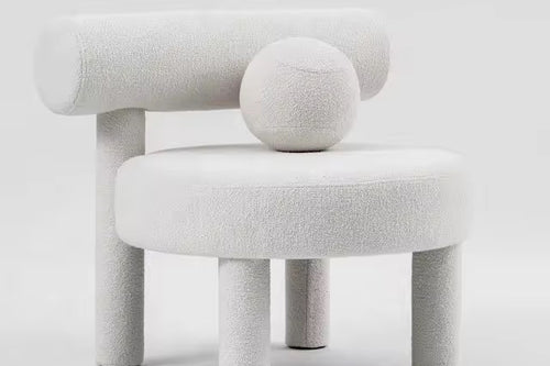 Shop the Cindy Bouclé Accent Chair, a luxury sculptural chair fully upholstered in bouclé with playful design details. Perfect for modern and high-end interiors.