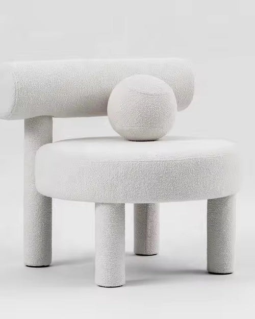 Shop the Cindy Bouclé Accent Chair, a luxury sculptural chair fully upholstered in bouclé with playful design details. Perfect for modern and high-end interiors.