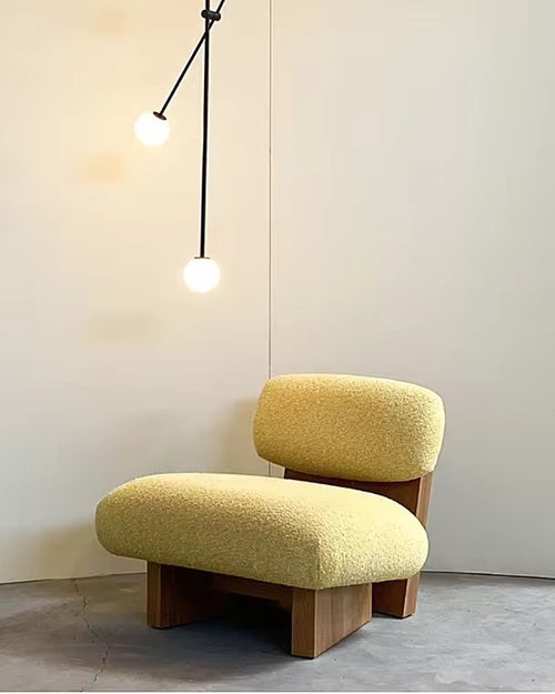 Cohu Accent Chair with a solid wooden base in Teak or White Ash finish, designed for modern luxury interiors with comfortable low seating.