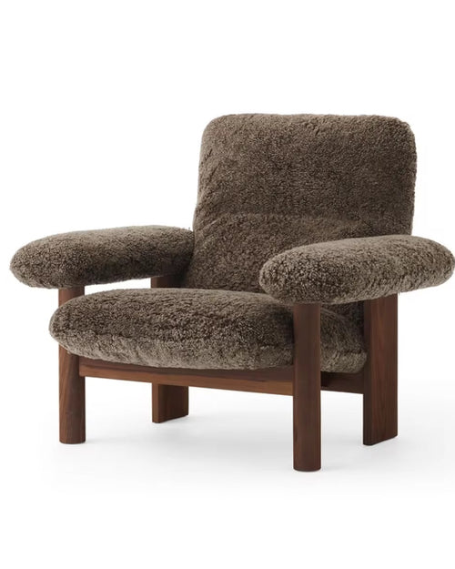 Brown textured armchair with wooden legs 