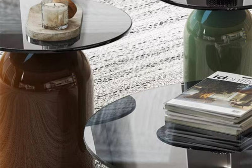 Three round glass tables in different colors