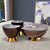 Set of three decorative side tables with gold bases.