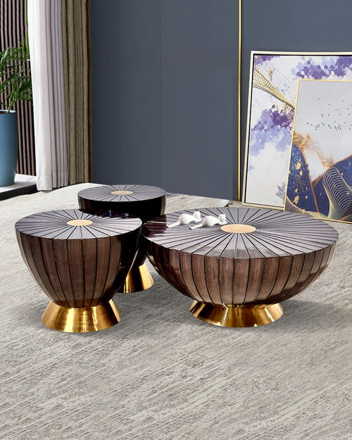 Set of three decorative side tables with gold bases.