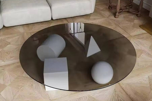 Round glass coffee table with geometric shapes