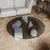 Round glass coffee table with geometric shapes