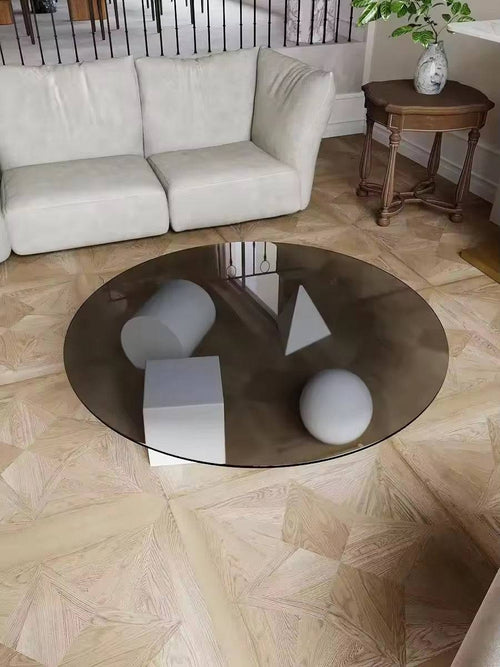 Round glass coffee table with geometric shapes