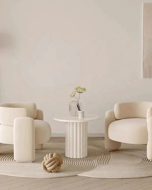 Gogh Chair highlighting its plush boucle texture and unique curved arms