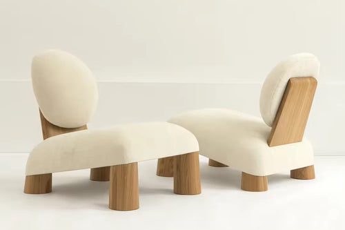 Sculptural modern lounge chair featuring a plush upholstered seat, slanted backrest, and White Ash Wood frame, designed for contemporary luxury interiors.