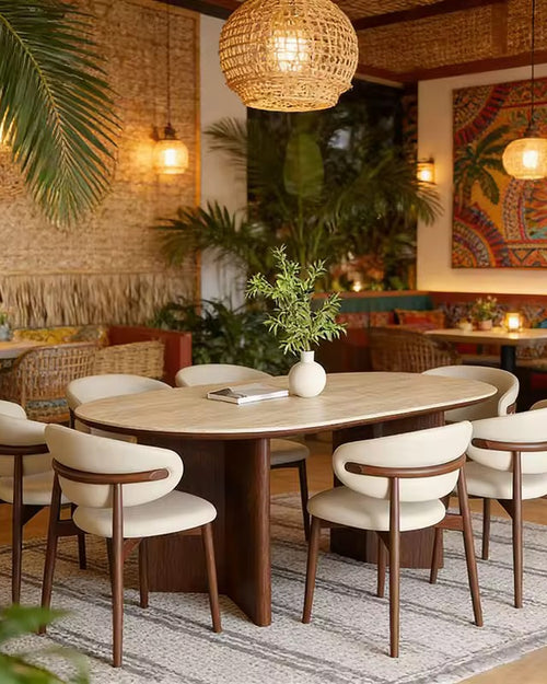 Gyros Dining Chair featuring a softly curved upholstered backrest, cushioned seat, and elegant wooden frame, designed for contemporary dining interiors.