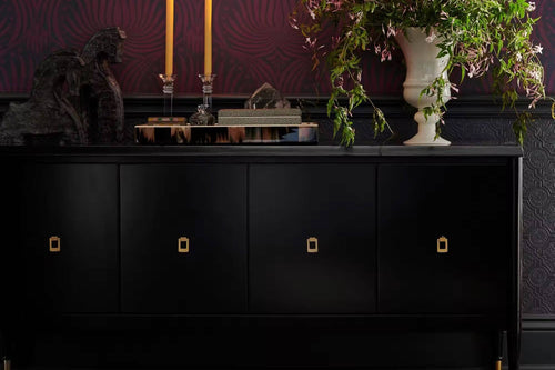 Bold black cabinet with gold pulls