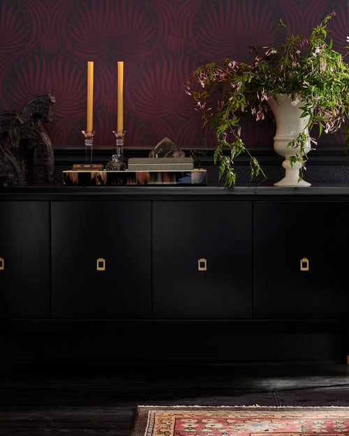 Bold black cabinet with gold pulls