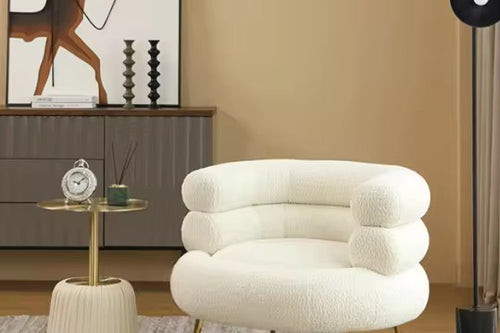 Shop the Harrier Round Accent Chair by Chair Collective – a modern luxury chair with plush boucle fabric, layered backrest, and sleek metal legs. Perfect for sophisticated living spaces in India.