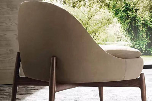 Back view of beige armchair with wooden legs 