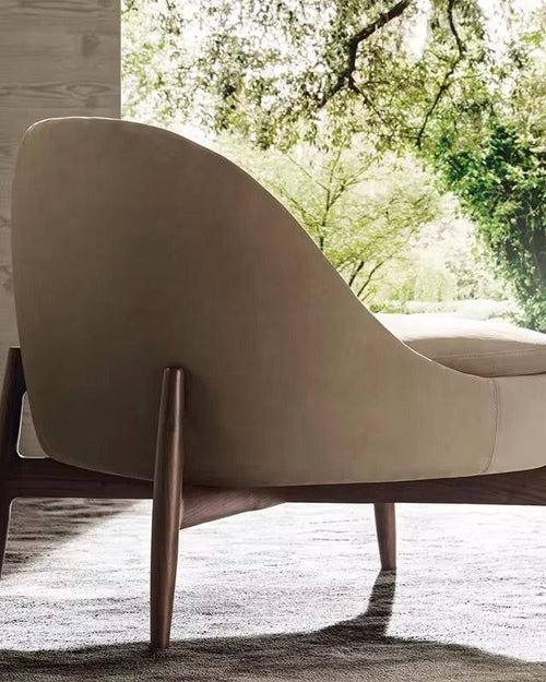 Back view of beige armchair with wooden legs 