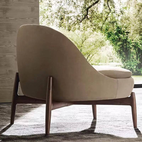 Back view of beige armchair with wooden legs 