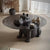 Modern coffee table with glass top and sculptural black bear base