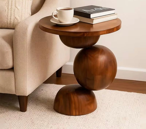 Sculptural end table crafted entirely from solid teak wood, featuring rounded geometric forms and a circular tabletop for contemporary luxury interiors.