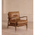 The Ember Chair embodies timeless sophistication, pairing buttery leather upholstery with a sleek, sculpted wooden frame. Gentle curves and slim armrests create an airy silhouette, while brass-capped legs add a note of refined luxury.