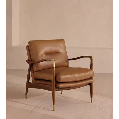 The Ember Chair embodies timeless sophistication, pairing buttery leather upholstery with a sleek, sculpted wooden frame. Gentle curves and slim armrests create an airy silhouette, while brass-capped legs add a note of refined luxury.
