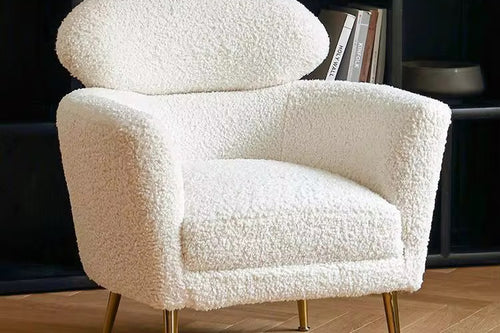 The Muse Chair is a study in refined comfort. Draped in plush boucle, its sculpted curves invite you to sink in, while the distinctive oval backrest offers both support and an iconic silhouette.