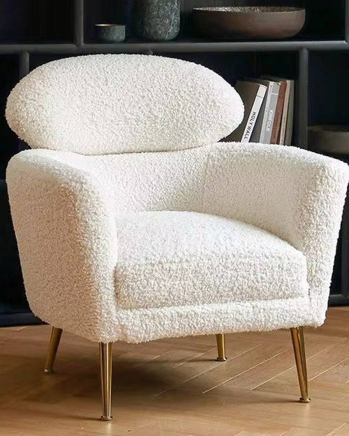 The Muse Chair is a study in refined comfort. Draped in plush boucle, its sculpted curves invite you to sink in, while the distinctive oval backrest offers both support and an iconic silhouette.