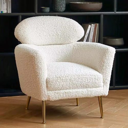 The Muse Chair is a study in refined comfort. Draped in plush boucle, its sculpted curves invite you to sink in, while the distinctive oval backrest offers both support and an iconic silhouette.