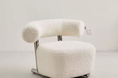 The Azure Chair is a striking blend of modern minimalism and tactile luxury. Its sculpted boucle seat wraps you in comfort, while the bold rolled backrest floats effortlessly above a sleek brushed steel frame.