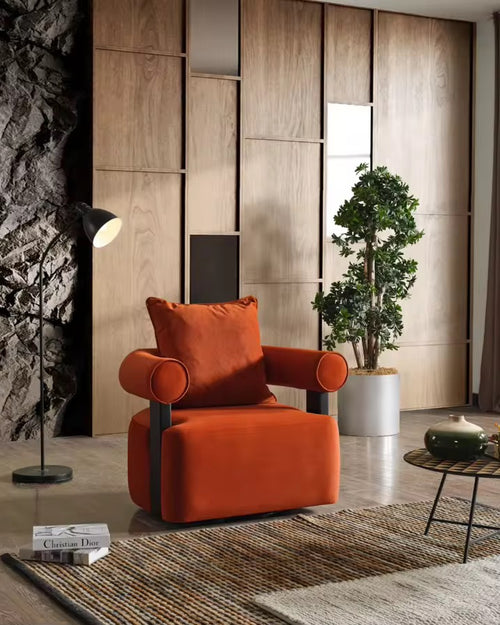 The Kyoto Chair is a statement in sculptural design—where strong architectural lines meet plush, enveloping comfort. Its cylindrical armrests and rich velvet upholstery exude sophistication, while the contrasting matte black supports add a touch of modern edge.